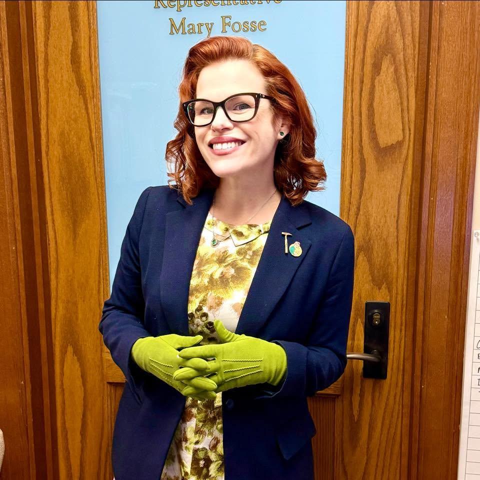 mary fosse in front of her office door