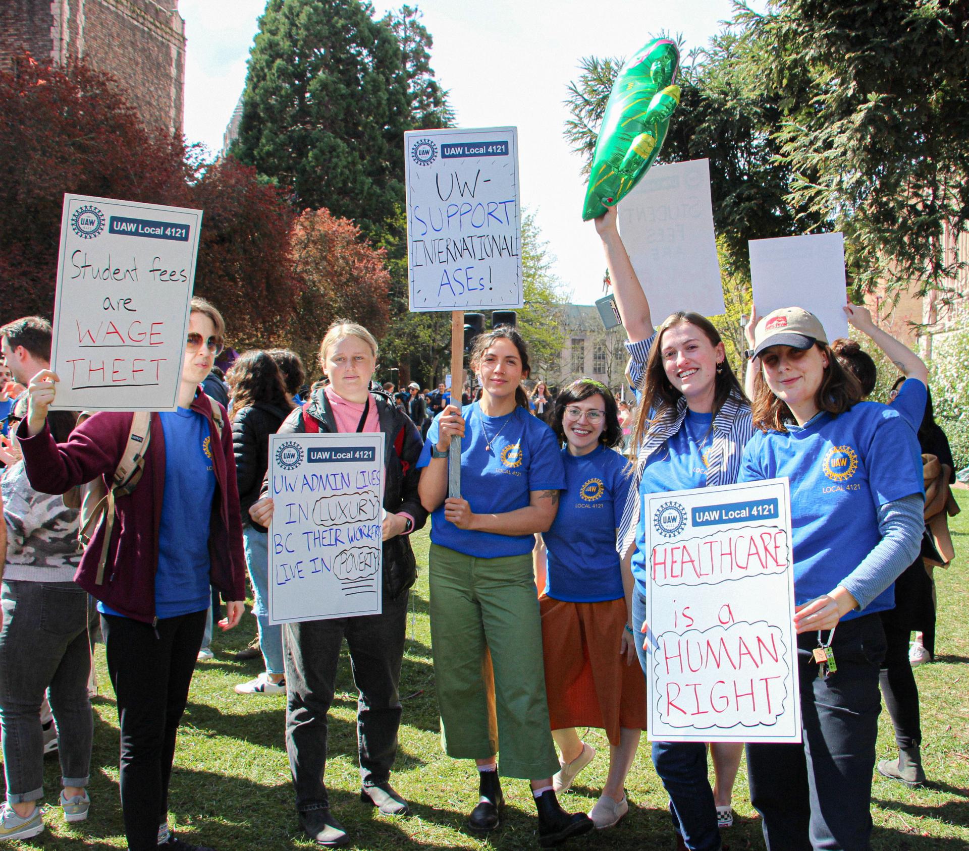 uaw supporters posing with signs