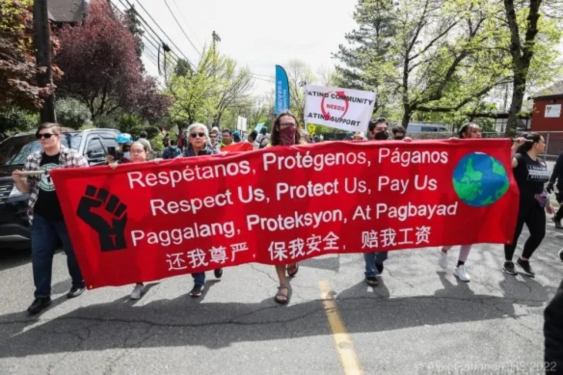 may day banner - respect us, protect us, pay us